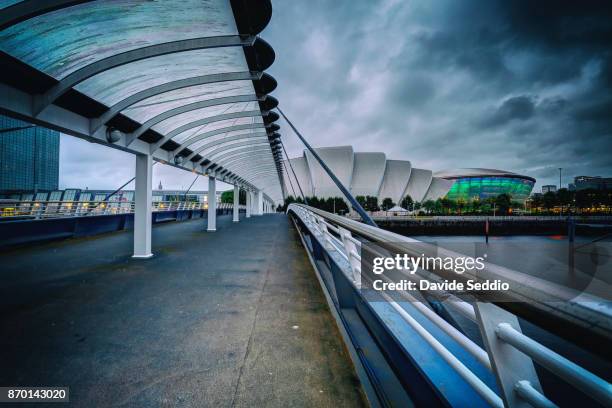 bell's bridge over the clyde river and clyde auditorium in the background - clyde auditorium fotografías e imágenes de stock