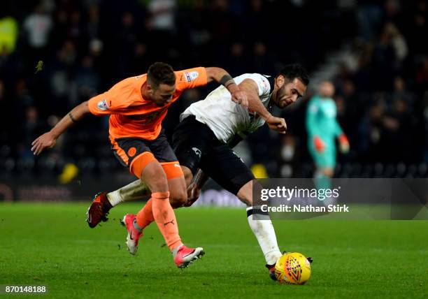 Bradley Johnson of Derby County and Roy Beerens of Reading in action during the Sky Bet Championship match between Derby County and Reading at iPro...