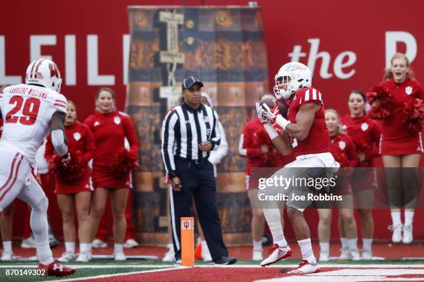 Devonte Williams of the Indiana Hoosiers makes a 23-yard touchdown catch in the first quarter of a game against the Wisconsin Badgers at Memorial...