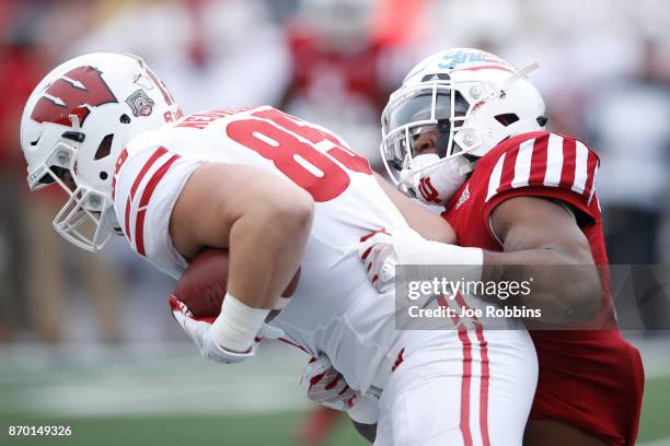 Chris Covington of the Indiana Hoosiers tackles Zander Neuville of the Wisconsin Badgers in the first quarter of a game at Memorial Stadium on...