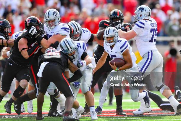 Alex Delton of the Kansas State Wildcats looks for running room during the first half of the game between the Texas Tech Red Raiders and the Kansas...