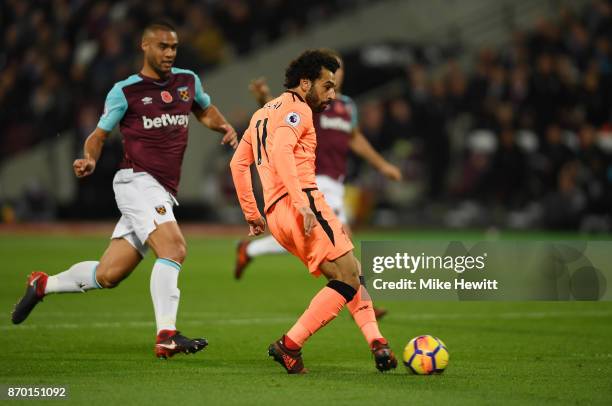 Mohamed Salah of Liverpool scores his sides first goal during the Premier League match between West Ham United and Liverpool at London Stadium on...