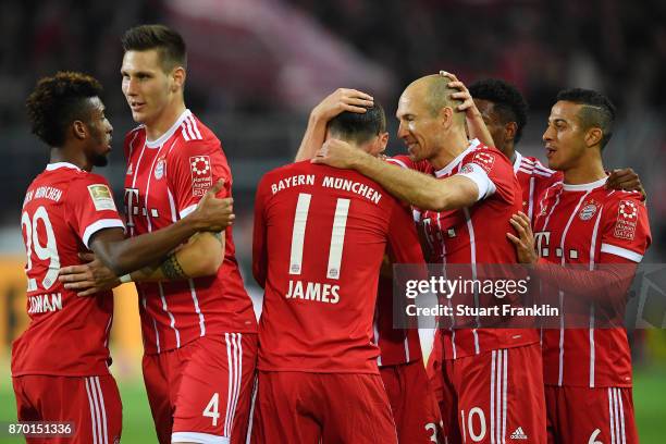 Arjen Robben of Bayern Muenchen celebrates with James Rodriguez of Bayern Muenchen and other players after he scored a goal to make it 0:1 during the...