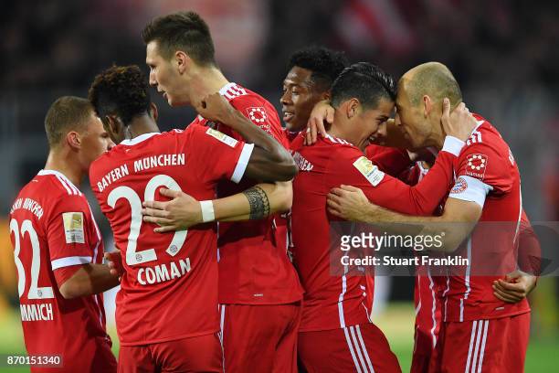 Arjen Robben of Bayern Muenchen celebrates with James Rodriguez of Bayern Muenchen and other players after he scored a goal to make it 0:1 during the...