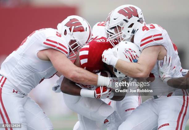 Ryan Connelly and Garret Dooley of the Wisconsin Badgers make a tackle against the Indiana Hoosiers in the first quarter of a game at Memorial...