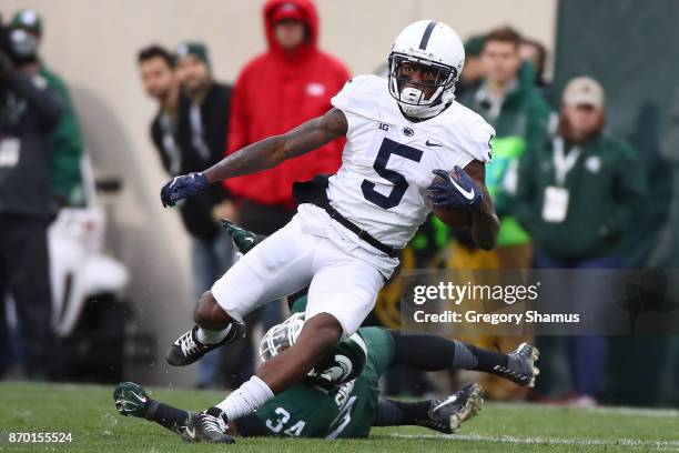 DaeSean Hamilton of the Penn State Nittany Lions gets around Antjuan Simmons of the Michigan State Spartans during the first half at Spartan Stadium...