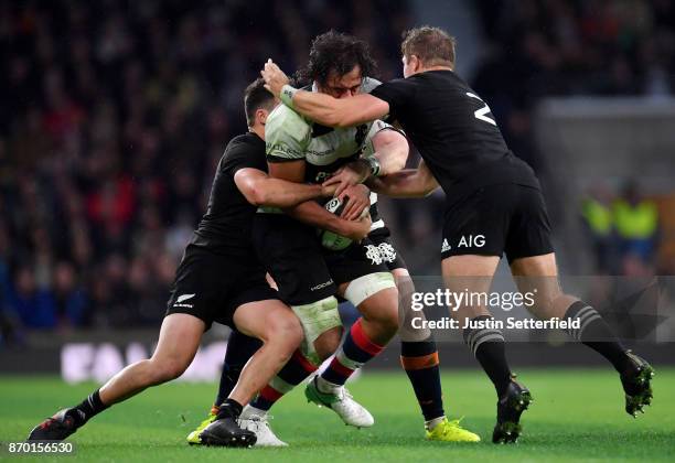 Steven Luatua of Barbarians is tackled by David Havili of New Zealand and Nathan Harris of New Zealand during the Killik Cup between Barbarians and...