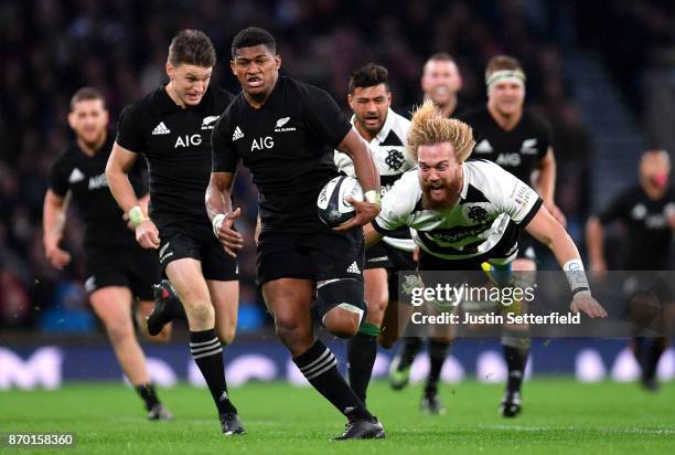 Waisake Naholo of New Zealand evades the tackle of Willie Britz of Barbarians during the Killik Cup between Barbarians and New Zealand at Twickenham...