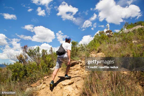 striding up a hill - villa de leyva stock-fotos und bilder