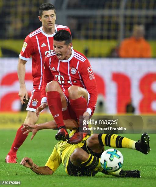 James Rodriguez of Bayern Muenchen is fouled by Oemer Toprak of Dortmund during the Bundesliga match between Borussia Dortmund and FC Bayern Muenchen...