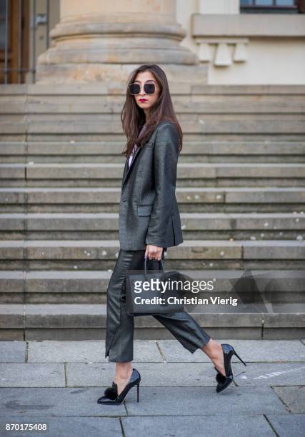 Nadja Ali wearing Lala Berlin suit, Jimmy Choo bag, Saint Laurent bag, Dior sunglasses, Chanel necklace on November 4, 2017 in Berlin, Germany.