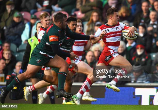 Lloyd Evans of Gloucester Rugby is tackled by George McGuigan of Leicester Tigers during the Anglo-Welsh Cup match at Welford Road on November 4,...