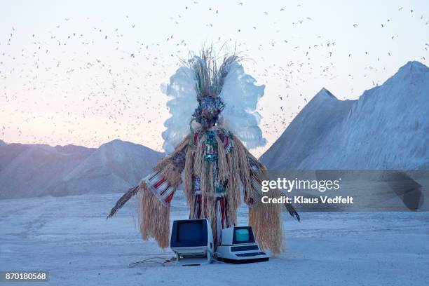 man wearing amazing witch doctor inspired hybrid costume with old computer parts - sorcier africain photos et images de collection