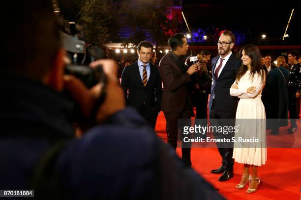 Vinicio Marchioni, Marco Giallini, Sabrina Ferilli are interviewed by Livio Beshir during a red carpet for 'The Place' during the 12th Rome Fest at...