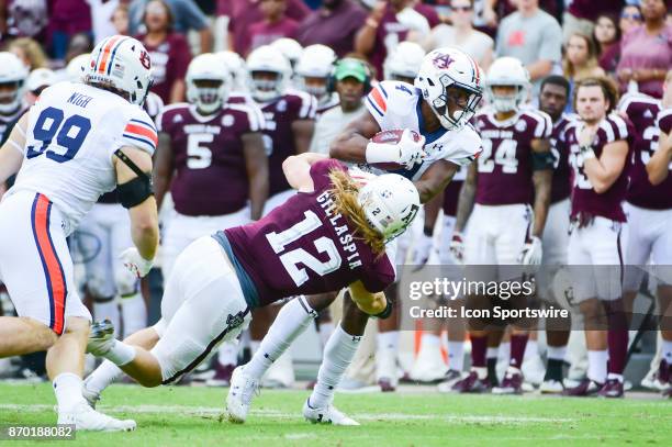 Texas A&M Aggies linebacker Cullen Gillaspia puts a huge hit on Auburn Tigers wide receiver Noah Igbinoghene during a second half punt return during...