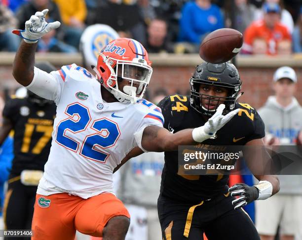 Running back Lamical Perine of the Florida Gators reaches out to catch a pass against Terez Hall of the Missouri Tigers in the fourth quarter at...