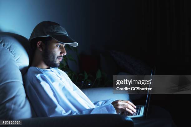 late night work on the laptop - saudi youth stock pictures, royalty-free photos & images