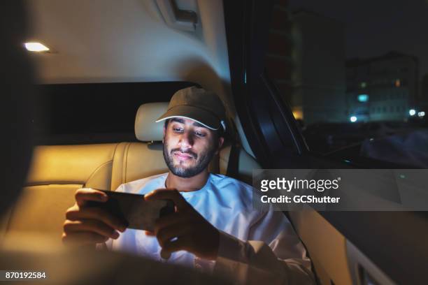 streaming football on a smart phone while riding a car - watching stock pictures, royalty-free photos & images