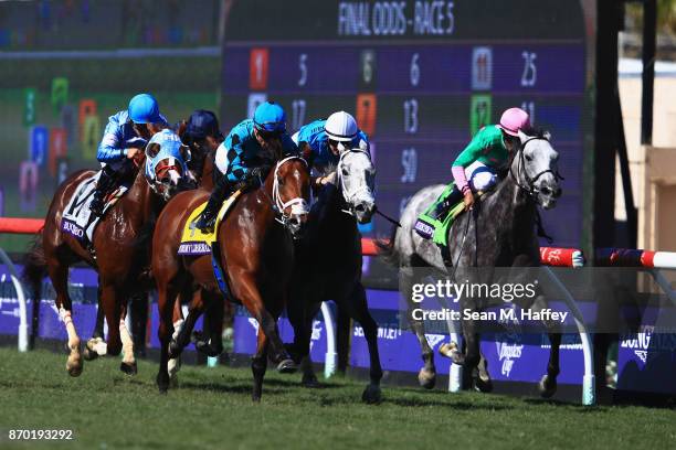 Stormy Liberal ridden by Joel Rosario wins the Breeders' Cup Turf Sprint ahead of Richard's Boy ridden by Flavien Prat and Disco Partner ridden by...