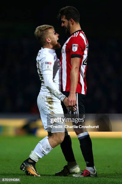 Yoann Barbet of Brentford squares up with Leeds Samuel Saiz during the Sky Bet Championship match between Brentford and Leeds United at Griffin Park...