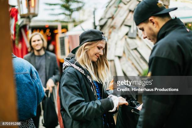 nightclub bouncer searching young woman"u2019s bag before letting her enter - club berlin stock pictures, royalty-free photos & images