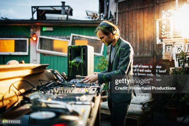 stylish dj performing using turntables at open air nightclub - dj fotografías e imágenes de stock