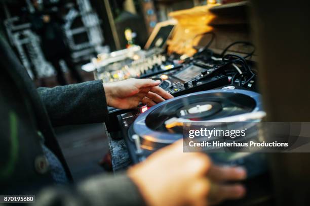 close up of dj mixing with vinyl at open air nightclub - black dj stock pictures, royalty-free photos & images