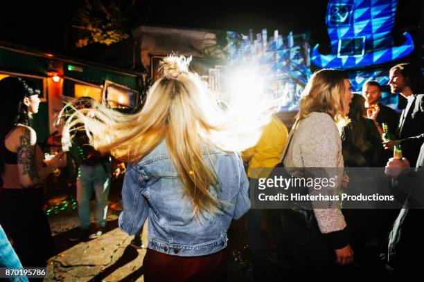 young woman"u2019s hair flowing as she dances at open air nightclub - club berlin stock pictures, royalty-free photos & images