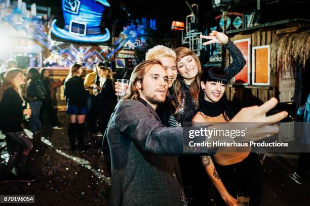 friends take selfie together on dance floor at open air nightclub - fun night party stockfoto's en -beelden