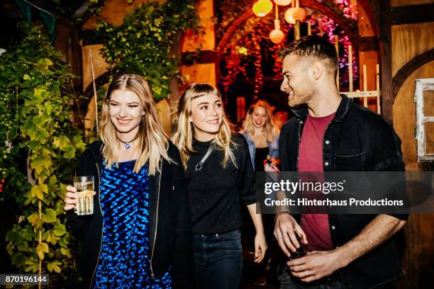 small group of friends taking break from dancing to get refreshment at nightclub - berlin nightlife stock pictures, royalty-free photos & images