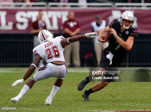 Nick Fitzgerald of the Mississippi State Bulldogs carries the ball as he gets around Jarell Addo of the Massachusetts Minutemen during the second...