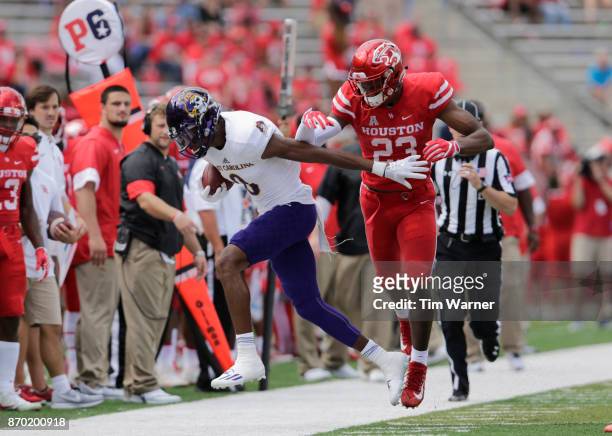 Terrell Williams of the Houston Cougars forces Tahj Deans of the East Carolina Pirates out of bounds in the third quarter at TDECU Stadium on...