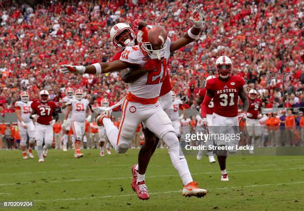 Mike Stevens of the North Carolina State Wolfpack tries to stop Ray-Ray McCloud of the Clemson Tigers during their game at Carter Finley Stadium on...