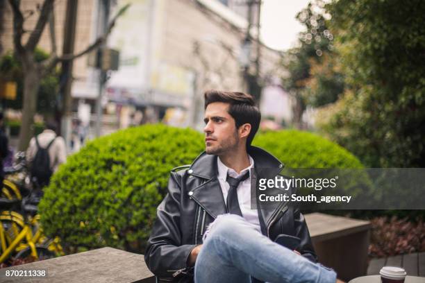 enjoying the coffee outdoors - motorcycle jacket stock pictures, royalty-free photos & images