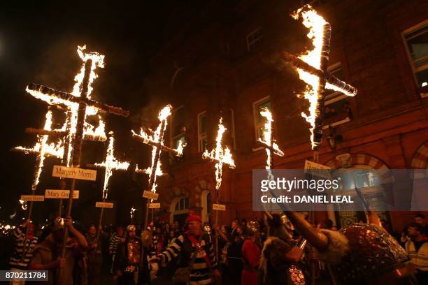 Revellers parade through the streets of Lewes in Sussex, southern England, on November 4 during the traditional Bonfire Night celebrations. -...