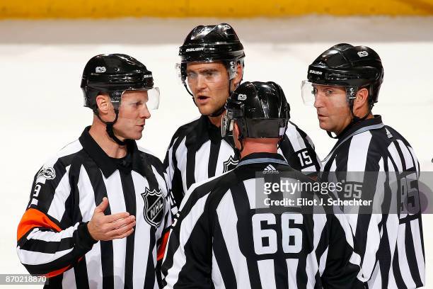 Referees Gord Dwyer, Jean Hebert and NHL Linesmen Darren Gibbs and Jonny Murray have a chat during a break in the action between the Columbus Blue...