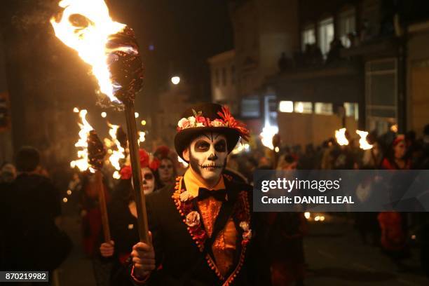 Revellers parade through the streets of Lewes in Sussex, southern England, on November 4 during the traditional Bonfire Night celebrations. -...