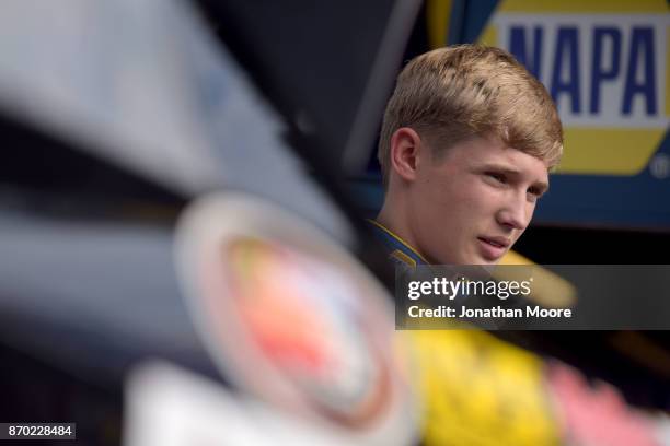 Derek Kraus, driver of the Carlyle Tools Toyota, stands next to his car during practice for the NASCAR K&N Pro Series West Coast Stock Car Hall of...