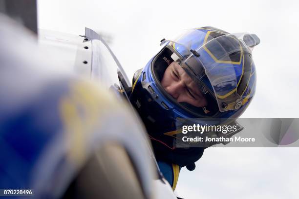 Todd Gilliland, driver of the NAPA Auto Parts Toyota, climbs into his car during practice for the NASCAR K&N Pro Series West Coast Stock Car Hall of...