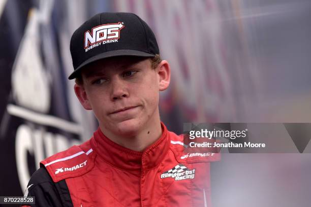 Riley Herbst, driver of the Terrible Herbst Toyota, stands next to his car during practice for the NASCAR K&N Pro Series West Coast Stock Car Hall of...