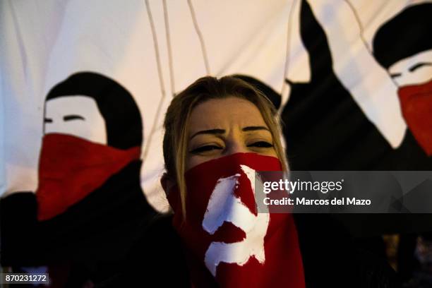 Woman with her face covered with soviet hammer and sickle during a demonstration for the 100th anniversary of the October Revolution.