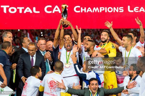 Wydad Casablanca's players celebrate with their trophy after winning the CAF Champions League final football match between Egypt's Al-Ahly and...