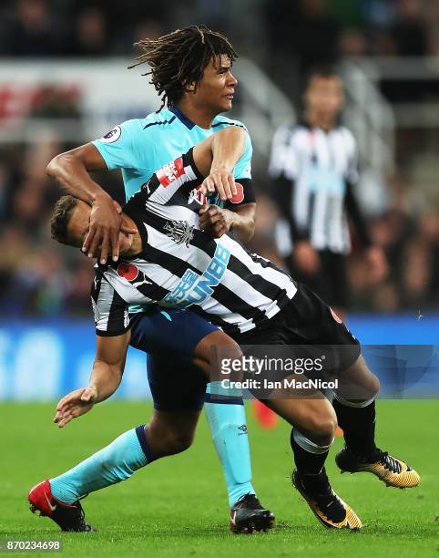 Nathan Ake of Bournemouth vies with Dwight Gayle of Newcastle United during the Premier League match between Newcastle United and AFC Bournemouth at...