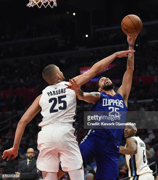 Chandler Parsons of the Memphis Grizzlies defends against Austin Rivers of the LA Clippers during the second half of the basketball game at Staples...
