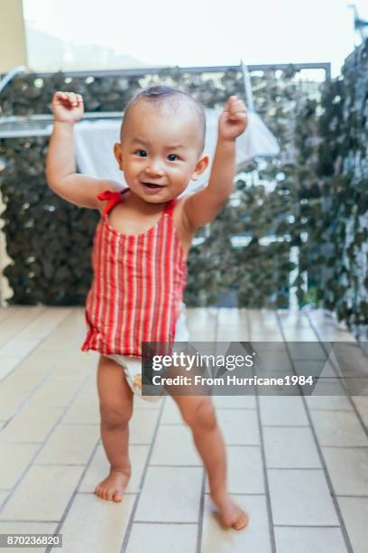 baby dancing on balcony - baby dancing stock-fotos und bilder