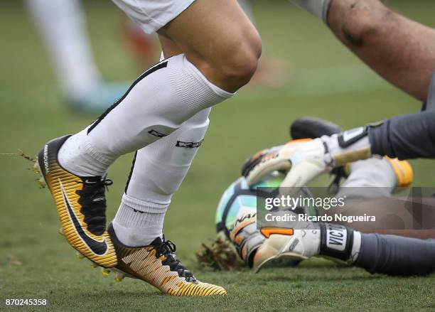 Ricardo Oliveira of Santos battles for the ball with Victor of Atletico Mineiro during the match between Santos and Atletico Mineiro as a part of...