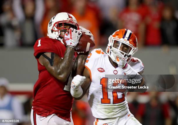 Von Wallace of the Clemson Tigers breaks up a pass in the endzone late in the game to Jaylen Samuels of the North Carolina State Wolfpack during...