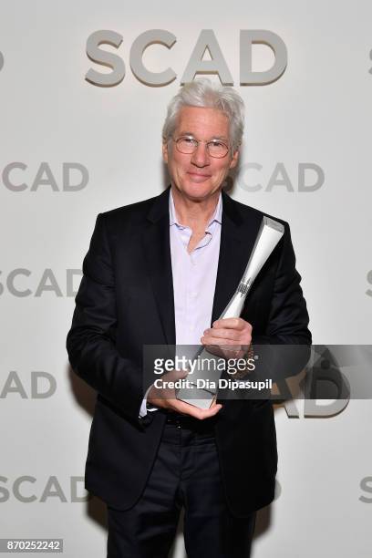 Actor Richard Gere poses backstage with the Lifetime Award at Trustees Theater during the 20th Anniversary SCAD Savannah Film Festival on November 4,...