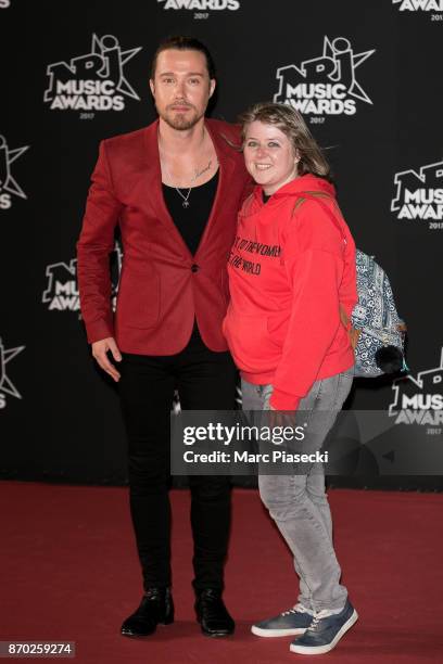 Singer Julien Dore and a fan attend the 19th 'NRJ Music Awards' ceremony on November 4, 2017 in Cannes, France.