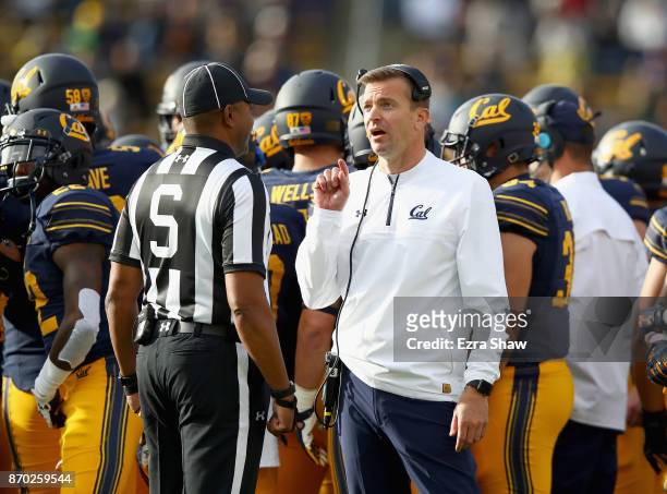 Head coach Justin Wilcox of the California Golden Bears talks to side judge Michael Marsh during their game against the Oregon State Beavers at...